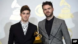 Andrew Taggart, left, and Alex Pall of The Chainsmokers pose in the press room with the award for best dance recording for "Don't Let Me Down" at the 59th annual Grammy Awards at the Staples Center on Feb. 12, 2017, in Los Angeles. 