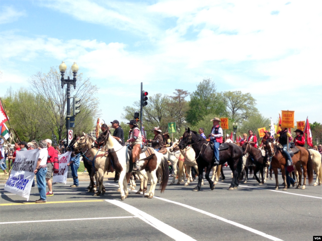 The Cowboy and Indian Alliance, a coalition of Native American tribes, ranchers, and farmers, stages a &quot;Reject and Protect&quot; protest against the Keystone XL oil pipeline project outside Capitol Hill, Washington D.C., April 22, 2014. (Diaa Bekheet/VOA)