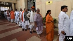 FILE - Members of Parliament stand in queue at Parliament House in New Delhi, India, July 17, 2017. Women reportedly hold only 12 percent of seats in both the lower and upper houses of parliament in the world's largest democracy.