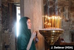 A Serb woman at prayer at Visoki Dečani, a medieval Serbian Orthodox Christian monastery located in Kosovo. Serbs from Belgrade come to pay their respects, traveling more than six hours into Kosovo to pray before their “holy king” Stefan Dečanski.