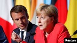 Prezidan fransè a, Emmanuel Macron, ak Chanselye Almay la, Angela Merkel, ki t ap patisipe nan yon konferans pou laprès aprè negosyasyon ki te dewoule sou entegrasyon politik magratwa Inyon Ewòp la ak kesyon defans nan Palè Elize a nan Pari, nan dat 28 out 2017. (Foto Achiv).