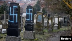 Graves desecrated with swastikas are seen in the Jewish cemetery in Quatzenheim, near Strasbourg, Feb. 19, 2019.