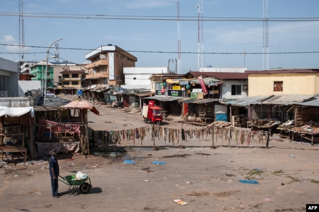 FILE - A man walks through an empty market in Old Market Road in Onitsha on May 30, 2017, during a shutdown in commemoration of the 50th anniversary of the Nigerian Civil War.