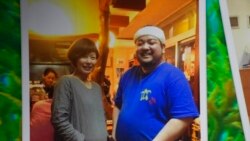 This photo provided by family shows Yoshihiko Takeuchi, right, posing for a photo with his friend Kayoko Kitatani, who visited his restaurant in Naha on the Okinawa islands, southern Japan, in 2015.