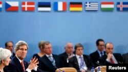 U.S. Secretary of State John Kerry (L) attends a NATO foreign ministers meeting in Brussels December 3, 2013.
