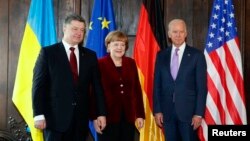 From left, Ukraine's President Petro Poroshenko, German Chancellor Angela Merkel and U.S. Vice President Joe Biden pose.