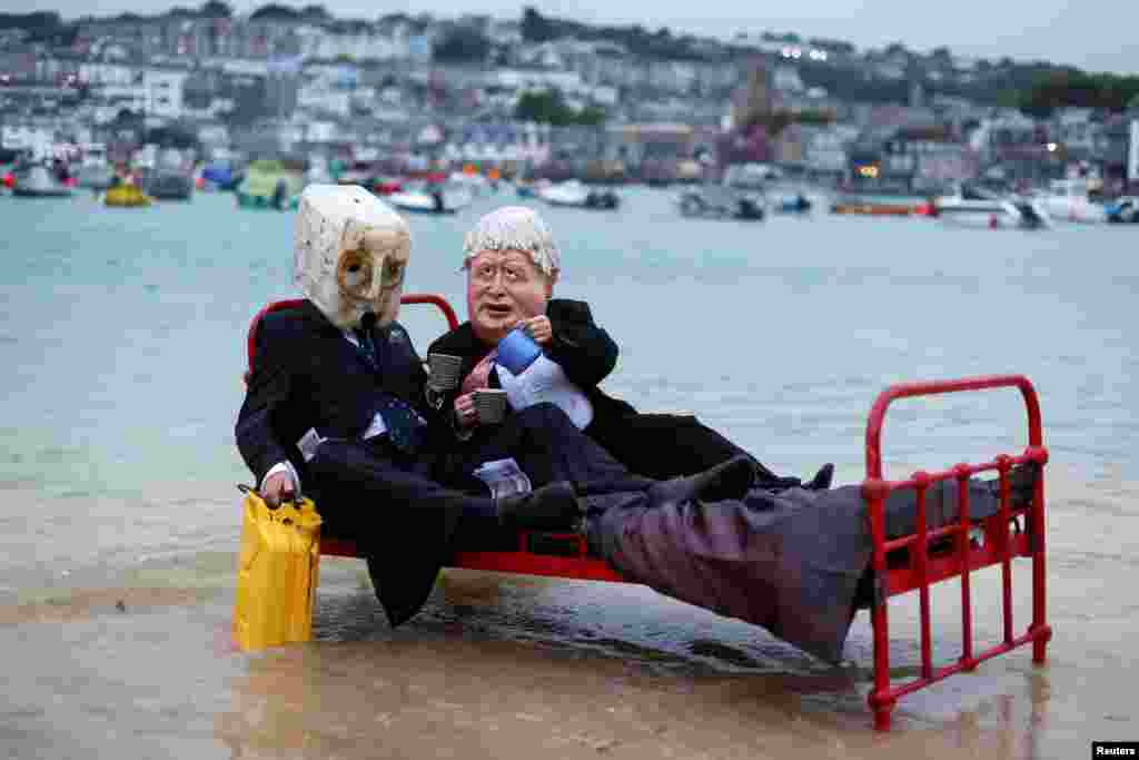 Activists from climate action group Ocean Rebellion demonstrate in St. Ives Harbor, Cornwall, Britain, ahead of the G7 summit.