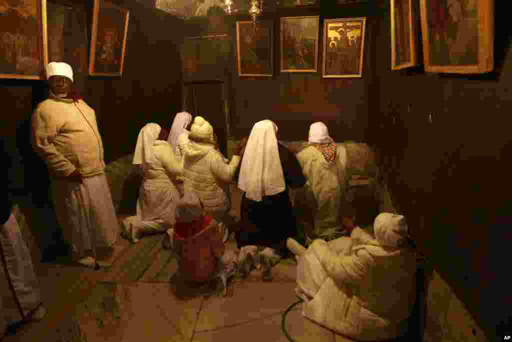 Christian pilgrim worshippers from Nigeria pray in the Grotto of the Church of Nativity in the West Bank town of Bethlehem on Christmas Eve, Dec. 24, 2013.