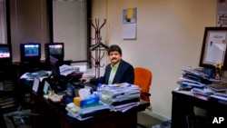 Pakistani journalist Hamid Mir sits in his office in Islamabad, Pakistan. Perhaps the most popular of Pakistan's news anchors, Mir, says both media owners and journalists operate under a cloud of fear, March 14, 2017. 