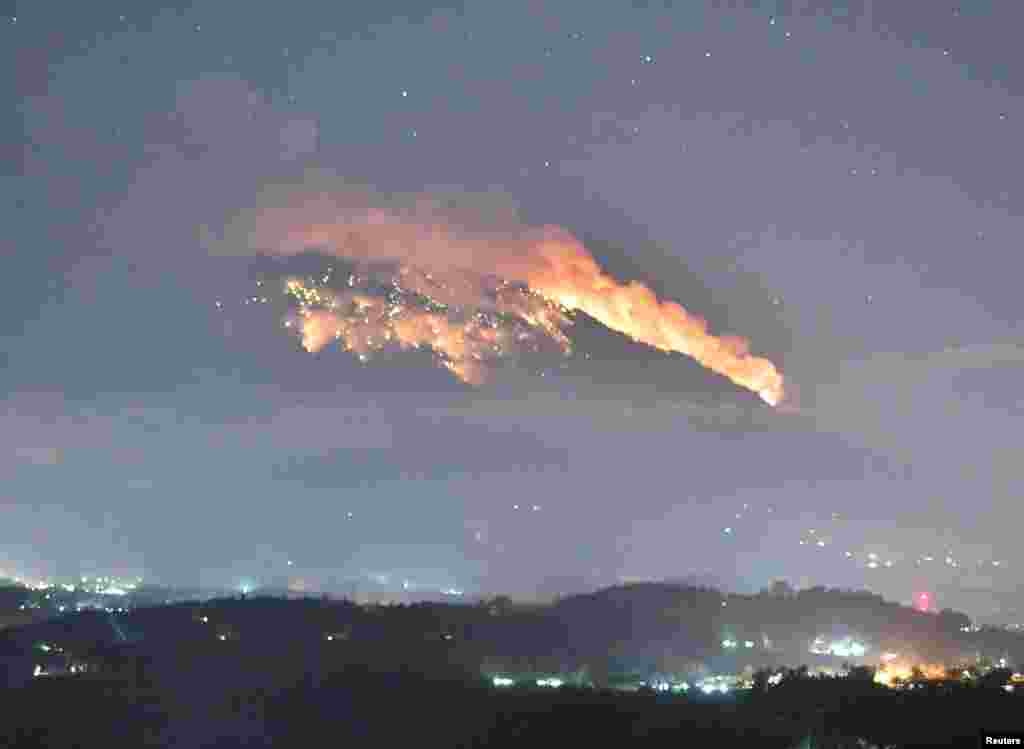 Mount Agung volcano erupts during the night, as seen from Bugbug village in Karangasem regency in Bali, Indonesia, July 2, 2018.