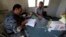 A member of the Free Revolutionary Police carries out an inspection on a measles vaccine in the southern Idlib, Sept. 17, 2014.