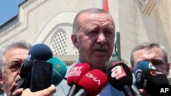FILE - Turkish President Recep Tayyip Erdogan speaks to the media after Friday prayers, in Istanbul, June 7, 2019. 