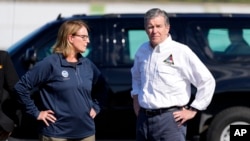 FILE - North Carolina Gov. Roy Cooper, right, and Deanne Criswell, administrator of the U.S. Federal Emergency Management Agency, await Vice President Kamala Harris, in Charlotte, North Carolina, Oct. 5, 2024.