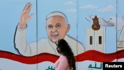 FILE - A mural of Pope Francis is seen on the wall of a church upon his upcoming visit to Iraq, in Baghdad, Iraq, Feb. 22, 2021. 