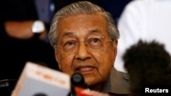 FILE - Mahathir Mohamad speaks during a news conference following the general election in Petaling Jaya, Malaysia, May 10, 2018. In an interview published Saturday, Mahathir said he wants to revisit the Trans-Pacific Partnership.