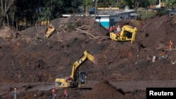 FILE - Members of a rescue team search for victims of a collapsed tailings dam owned by Brazilian mining company Vale SA, in Brumadinho, Brazil, Feb. 10, 2019.