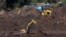 FILE - Members of a rescue team search for victims of a collapsed tailings dam owned by Brazilian mining company Vale SA, in Brumadinho, Brazil, Feb. 10, 2019.