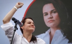 FILE - Svetlana Tikhanovskaya, candidate for the presidential elections, reacts during a meeting with her supporters in Minsk, Belarus, July 19, 2020.