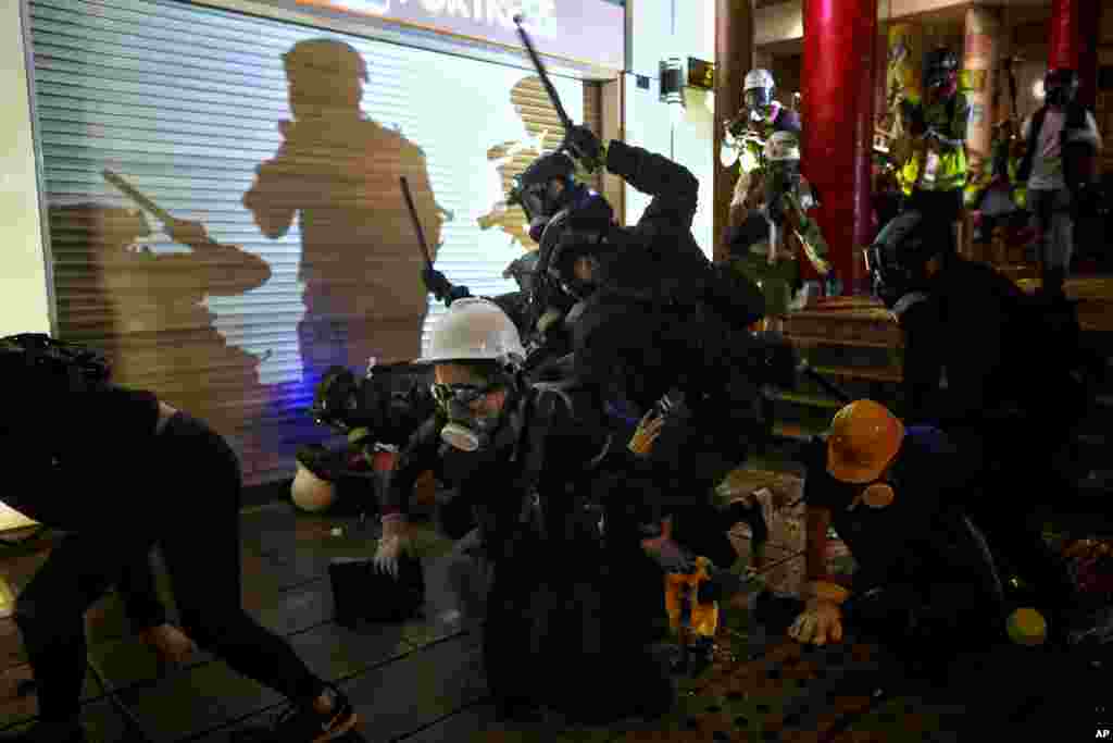 Policemen charge at protesters during the anti-extradition bill protest at Tsim Sha Tsui in Hong Kong.