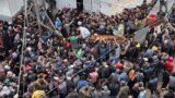 (FILE) Palestinians gather to receive bread from a bakery, amid the Israel-Hamas conflict, amid the ongoing conflict between Israel and Hamas, in Deir Al-Balah in the central Gaza Strip, November 29, 2024.