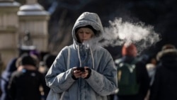 FILE - A person walks in freezing cold temperatures in New York City on January 17, 2024. Temperature highs in the city are expected to hit 25F (-3.9C). (Photo by ANGELA WEISS / AFP)