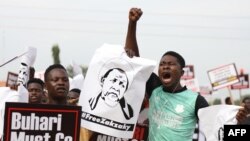 A protester shouts and raises his fist during a demonstration in Abuja on June 12, 2021, as Nigerian activists called for nationwide protests over what they criticize as bad governance and insecurity in Nigeria.