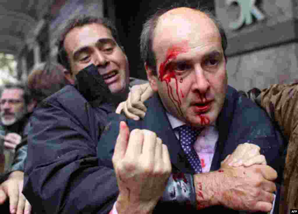 RETRANSMISSION FOR ALTERNATIVE CROP - A bodyguard, left, leads Costis Hatzidakis, former development minister in the previous, conservative government , away after he was attacked by protesters in Athens on Wednesday Dec. 15, 2010. Protesters clashed