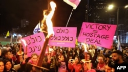 People light candles and hold placards during an anti-government protest calling for action to secure the release of Israeli hostages held captive since the October 7, 2023 attacks by Palestinian militants in the Gaza Strip, outside the Israeli Defence Mi