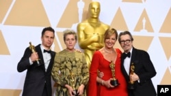 Sam Rockwell, from left, winner of the award for best performance by an actor in a supporting role for "Three Billboards Outside Ebbing, Missouri", Frances McDormand, winner of the award for best performance by an actress in a leading role for "Three Billboards Outside Ebbing, Missouri", Allison Janney, winner of the award for best performance by an actress in a supporting role for "I, Tonya", and Gary Oldman, winner of the award for best performance by an actor in a leading role for "Darkest Hour", pose in the press room at the Oscars, March 4, 2018, at the Dolby Theatre in Los Angeles.