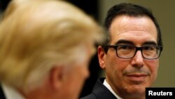 US Treasury Secretary Steve Mnuchin listens to US President Donald Trump speak during a strategic initiatives lunch at the White House in Washington, Feb. 22, 2017.