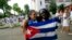 FILE - Recently released dissidents Haydee Gallardo (L) and Sonia Garro hold the Cuban national flag during a march in Havana, Jan. 11, 2015. 