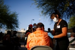 A healthcare worker from the El Paso Fire Department administers the Moderna vaccine against the COVID-19 at a vaccination center in El Paso, Texas, on May 7, 2021. (Jose Luis Gonzalez/Reuters)