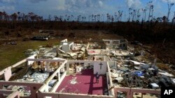 Pastor Jeremiah Saunders poses for a photo among the ruins of his church that was destroyed by Hurricane Dorian, in High Rock, Grand Bahama, Bahamas, Sept. 11, 2019. 