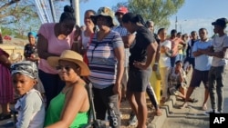 Namibians queue to cast their votes in a presidential election in Windhoek, Namibia, Nov. 27, 2024. 