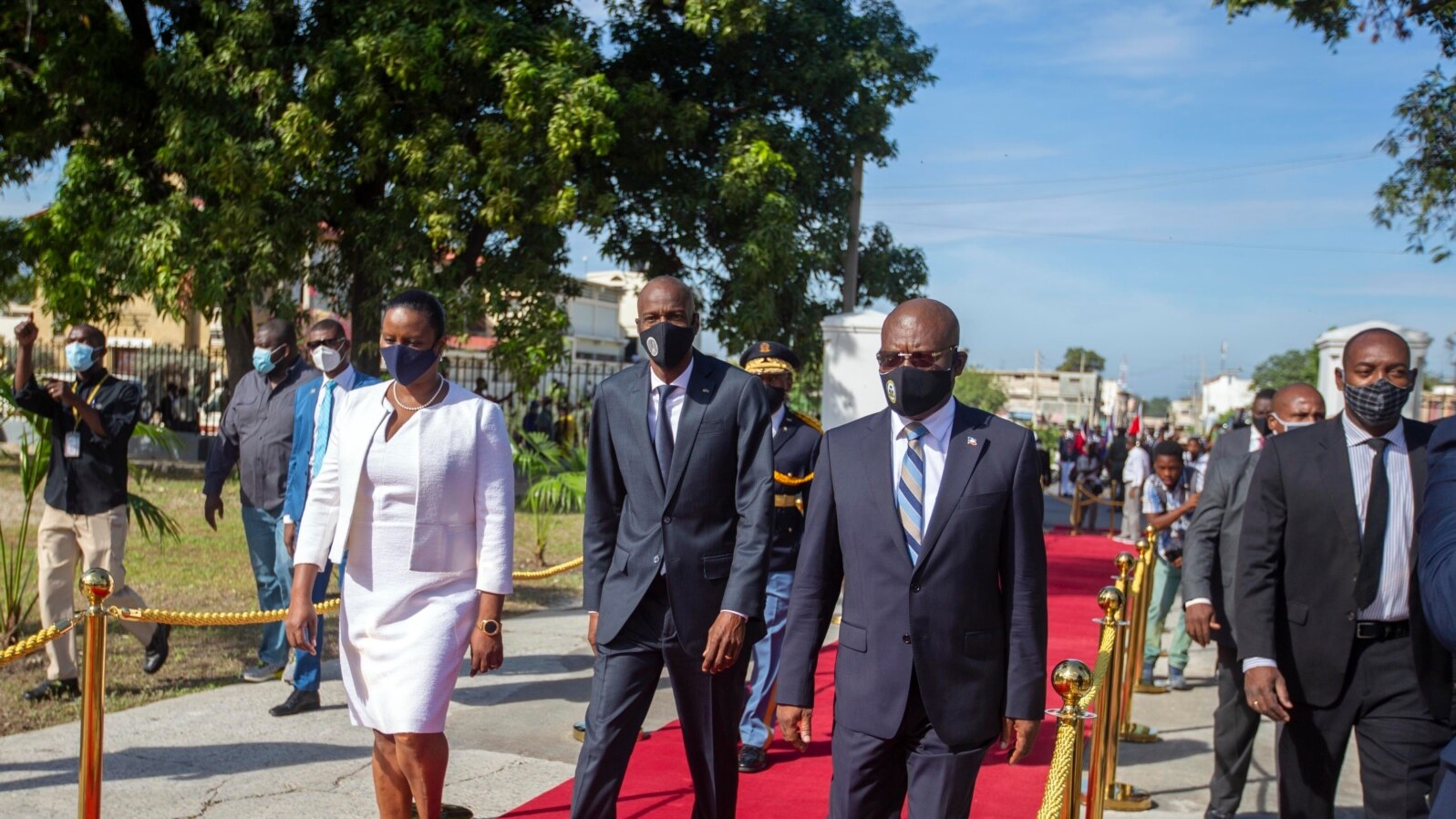 FILE - Haiti's President Jovenel Moise, center, accompanied by his wife Martine, and Prime Minister Joseph Jouthe, center right, in Port-au-Prince, Haiti. 