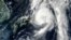 A NASA satellite image shows Typhoon Mindulle(top) over Japan, August 22, 2016.