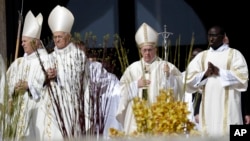 Pope Francis, second from right, arrives in St. Peter's Square at the Vatican to celebrate a Mass on the Sunday of Divine Mercy, April 8, 2018. 