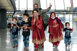 کابل سے واشنگٹن ڈی سی پہنچنے والا ایک افغان خاندان کے چہروں پر خوشی ہے۔ 27 اگست 2021