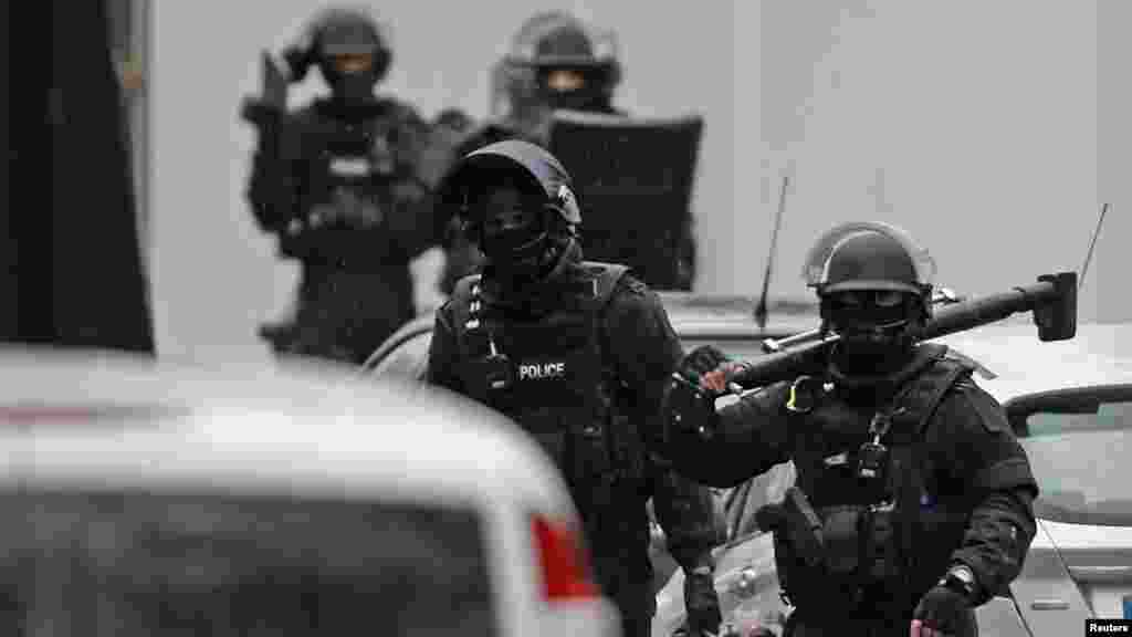 Members of French special police forces of Research and Intervention Brigade (BRI) are seen at the scene of a shooting in the street of Montrouge near Paris, Jan. 8, 2015. 