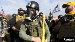 FILE - Supporters of U.S. President Donald Trump along with members of the far-right group Proud Boys gather for a rally to protest the results of the election, in Washington, Dec. 12, 2020.