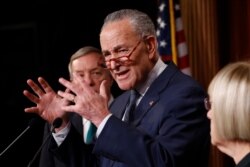 Senate minority leader, Charles Schumer, D-NY.,at podium gestures as Sen. Dick Durbin, D-Il., left, and Sen. Patty Murray, D-Wash., right, listen during a news conference in the Senate media room at the Capitol, Jan. 21, 2020, in Washington.