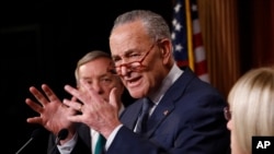 FILE: Senate Majority Leader Charles Schumer, D-NY.,at podium gestures as Sen. Dick Durbin, D-Il., left, and Sen. Patty Murray, D-Wash., right, listen at the Capitol, Jan. 21, 2020, in Washington. On Thursday, Schumer got an OK of the debt limit bill, avoiding a U.S. default. 