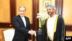 Oman's Foreign Minister Sayyid Badr al-Busaidi, right, receives Iranian Foreign Minister Abbas Araghchi in Muscat on Oct. 14, 2024, in this handout picture provided by the Oman News Agency.