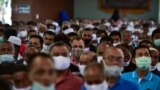 People wearing face masks attend a meeting by Thai government officials discussing the economic impact of the COVID-19 coronavirus in the border area with Malaysia at Sungai Kolok town in Thailand's southern province of Narathiwat on September 12, 2020 as