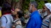 People queue up at a polling booth to cast their vote in Naira, south of Srinagar, Indian-controlled Kashmir, Sept. 18, 2024. 