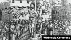 William Tyndale is burnt at the stake in Belgium; he cries, "Lord ope the king of England's eies." From an Elizabethan edition of Foxe's Martyrs. (Wikimedia)