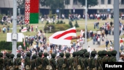 Law enforcement officers stand guard during an opposition demonstration to protest against presidential election results, in Minsk, Belarus, Aug. 23, 2020. 