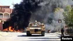 A military vehicle of the Iraqi army with Shi'ite Popular Mobilization Forces (PMF) is seen during a fight with Islamic State militants in Tal Afar, Iraq, Aug. 26, 2017.