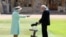 Captain Sir Thomas Moore, who raised 39 million pounds ($53 million) for health service charities by walking laps of his Bedfordshire garden, receives his knighthood from Britain's Queen Elizabeth at Windsor Castle in Windsor, England, July 17, 2020.