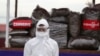 A police wearing a personal protective equipment stands in front of seized illegal drugs before being burnt during a destruction ceremony to mark International Day against Drug Abuse and Illicit Trafficking outside Yangon, Myanmar, June 26, 2020.